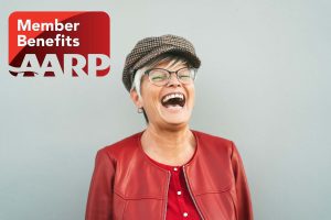 Woman laughing and enjoying herself with an AARP logo next to her.