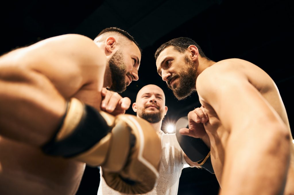 Two male boxers are exchanging angry glances representing Medigap vs. Medicare Advantage