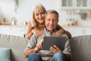 Senior Husband And Wife Using Digital Tablet Together At Home qualifying for Special Enrollment Period