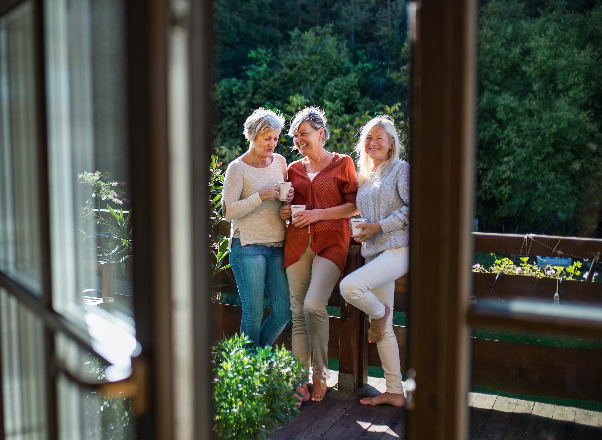 Senior women friends standing outdoors on terrace, resting with new 2023 Medicare Premiums and Deductibles