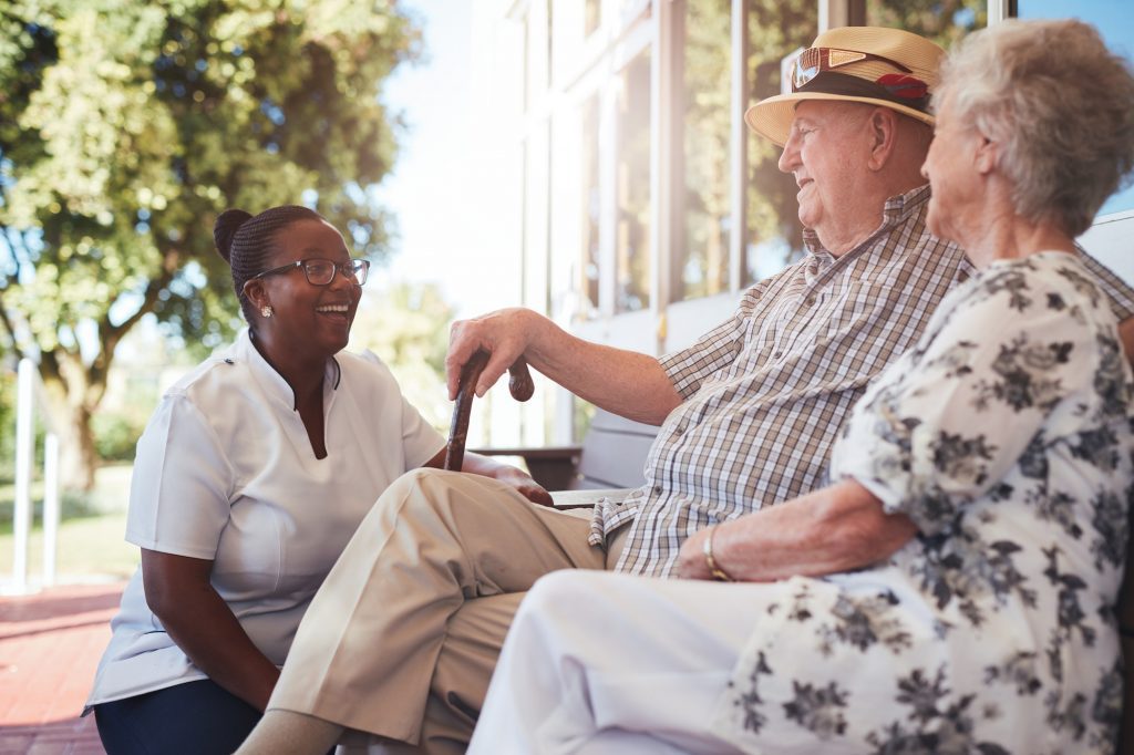 Medicare beneficiary with hospice caregiver sitting outside