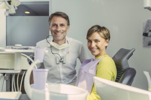 Dentist and patient with Medicare with Dental Implants