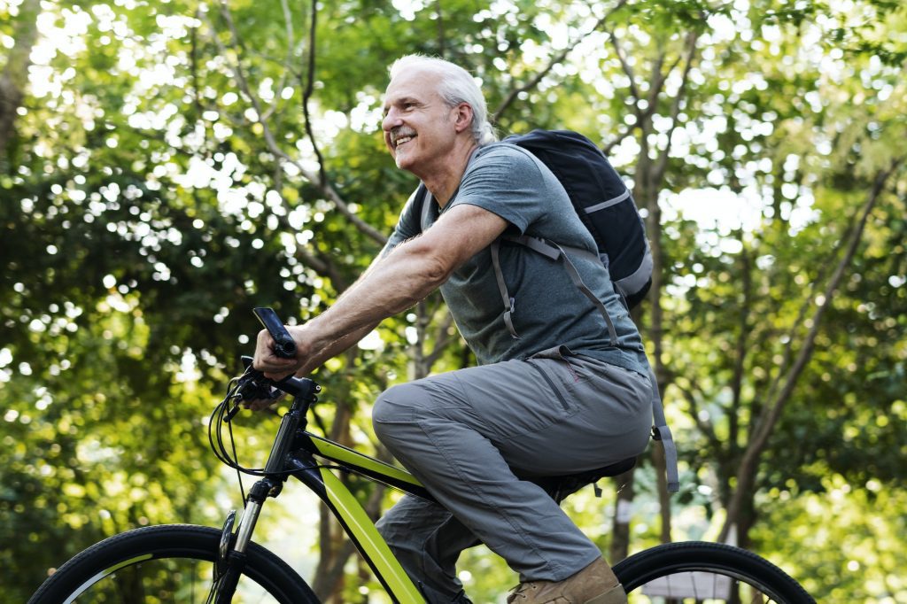 Senior man biking in the park during Medicare Advantage Open Enrollment Period