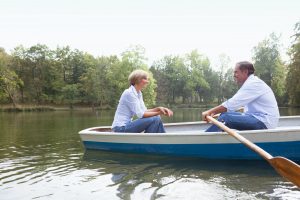 Middle aged couple in a rowboat with HSA (Health Savings Account)