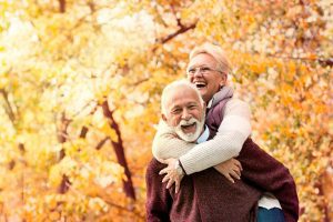 Couple in front of fall leaves, asking about Plan G and Plan N