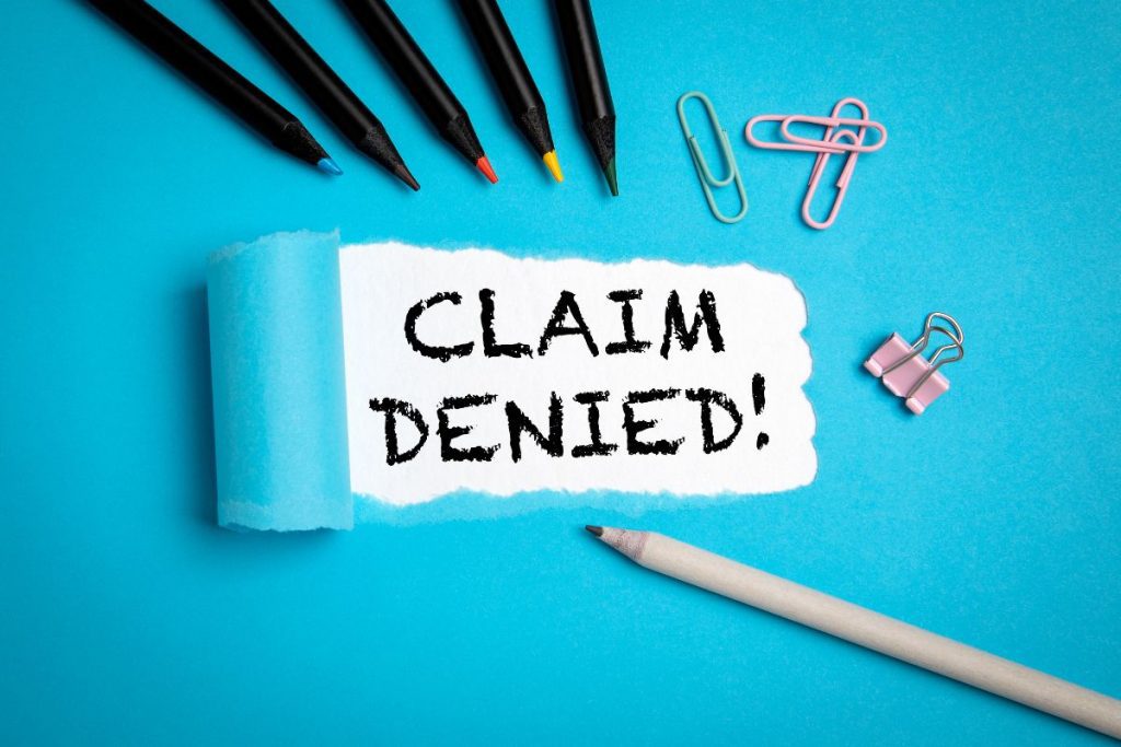 The words "Claim denied!" on paper.