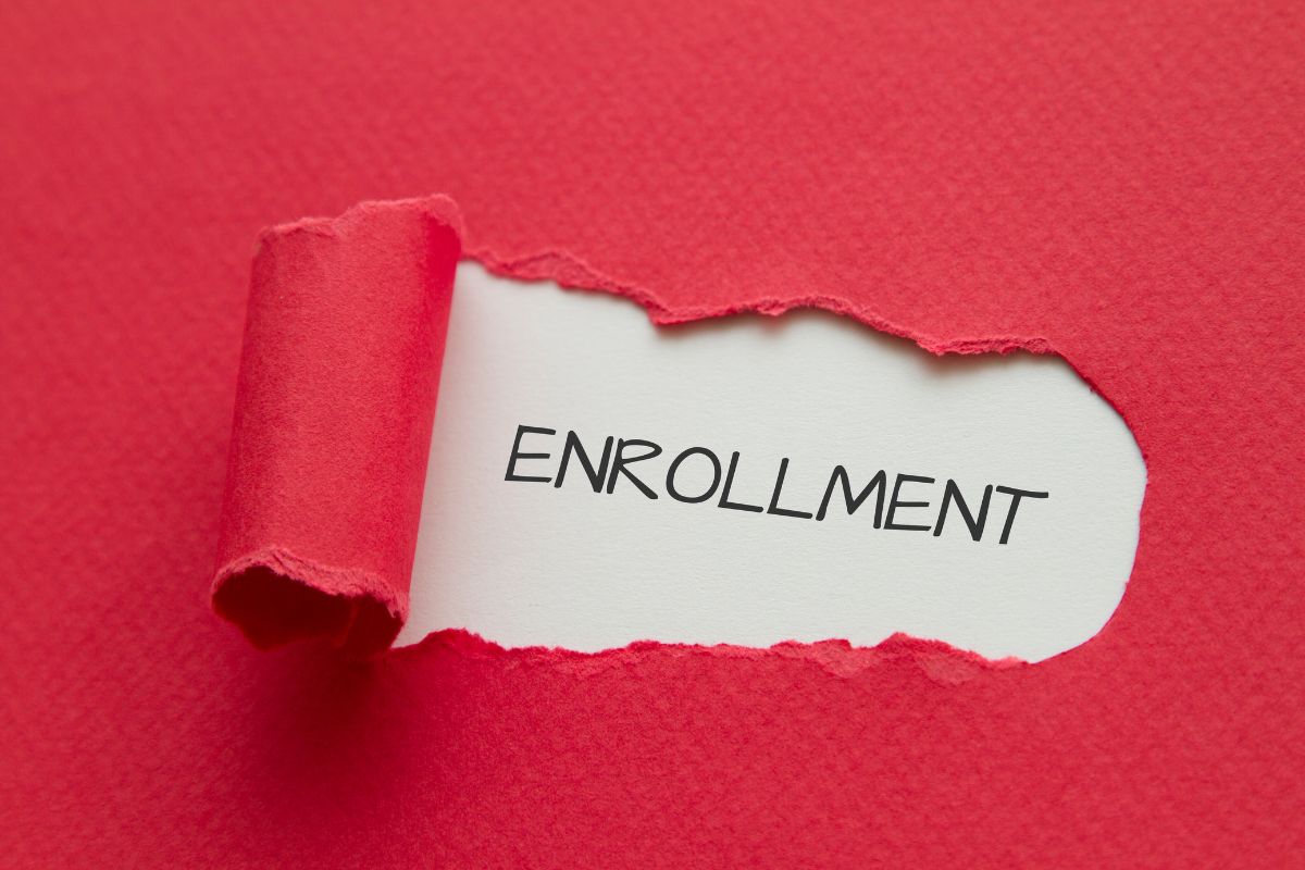 The word "enrollment" showing through red paper.
