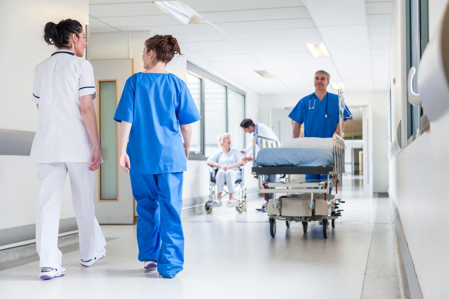 Healthcare providers walking in hospital hallway