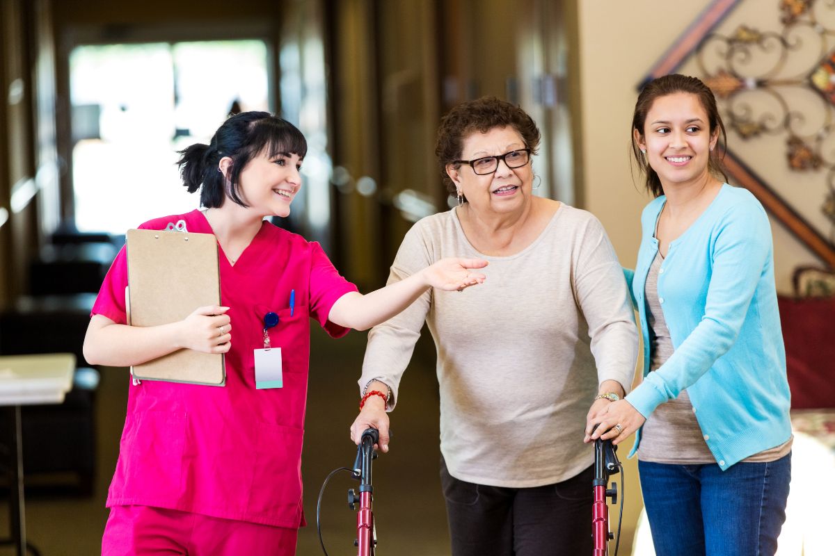 Nurse showing elderly woman and her daughter the assisted living facility