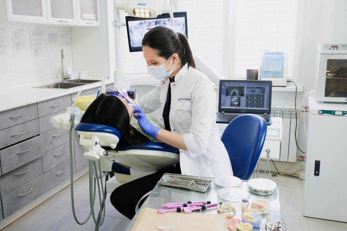 Woman in a dental chair, getting Medicare dental coverage