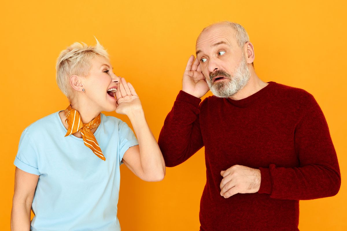 Woman yelling into man's ear