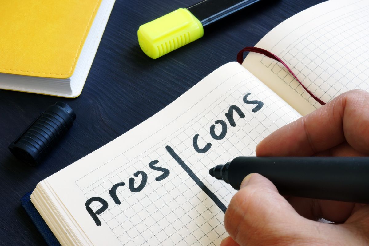 Person writing a pros and cons list for Medicare Advantage