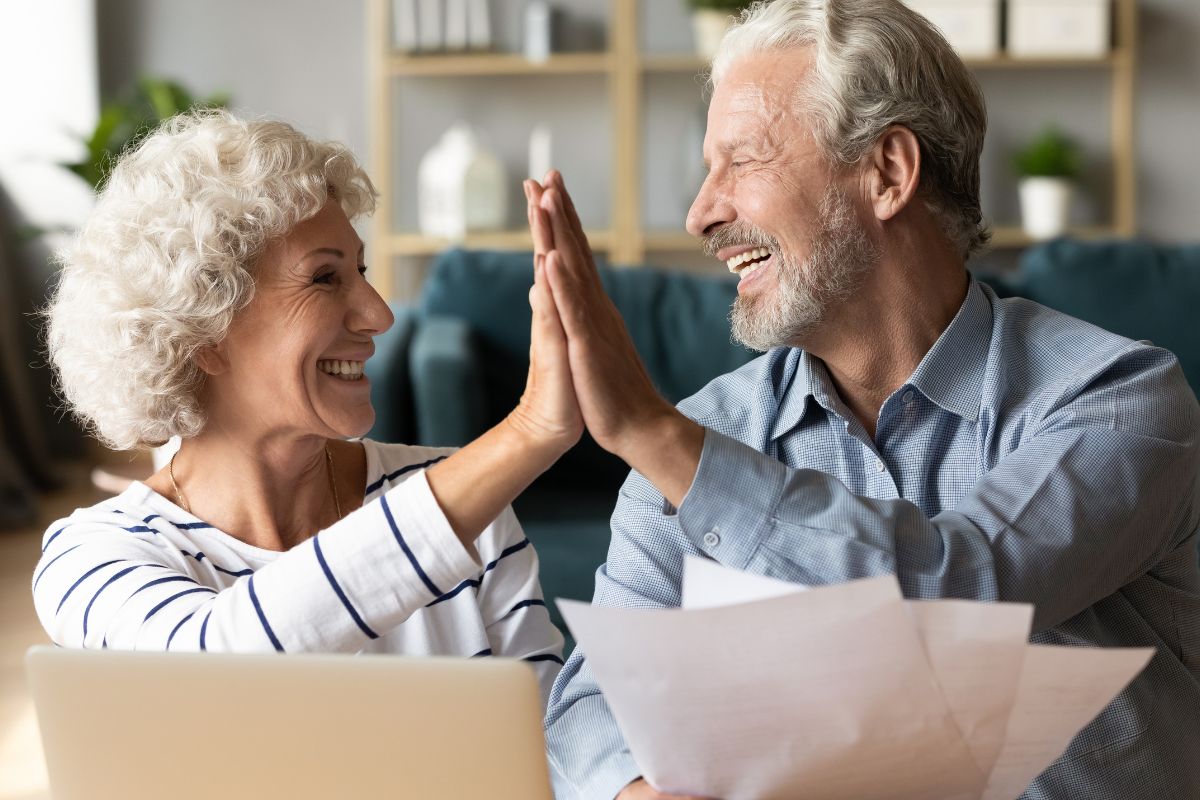 Couple high-fiving after switching to a 5-star medicare advantage plan