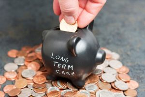 Putting money in a piggy bank to save for long term care services