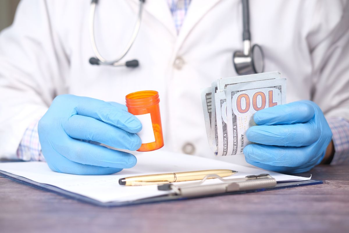 Doctor with pills and cash