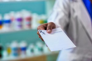 Doctor handing patient a prescription