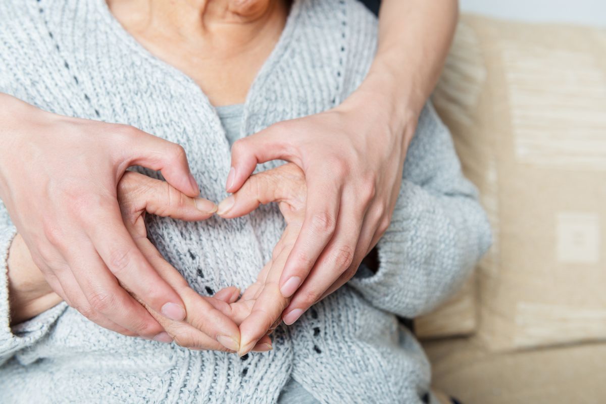 Person making a heart with their hands
