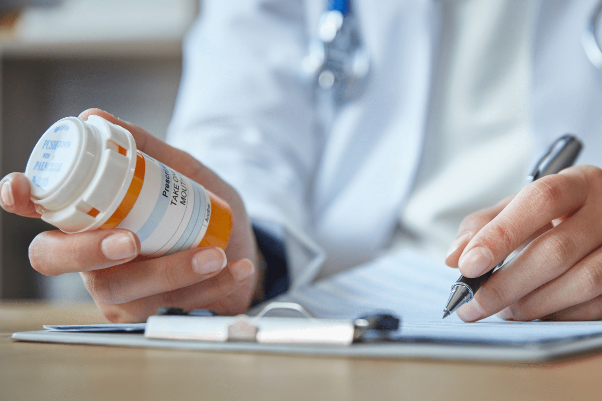 Pharmacist calculating price of prescription