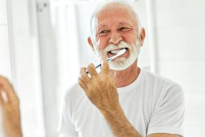 Medicare beneficiary brushing his teeth