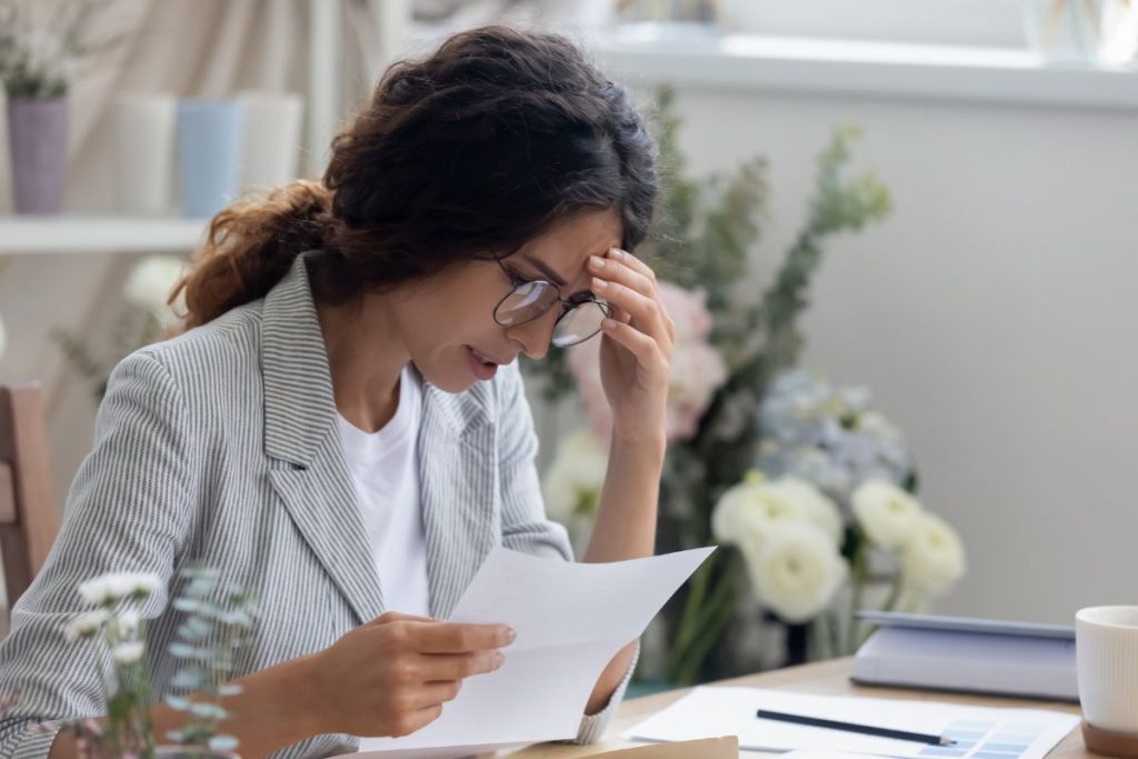 Woman reading a Medicare claim denial