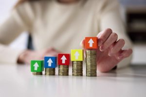 Coins stacking higher and higher, signifying the Medicare cost increase