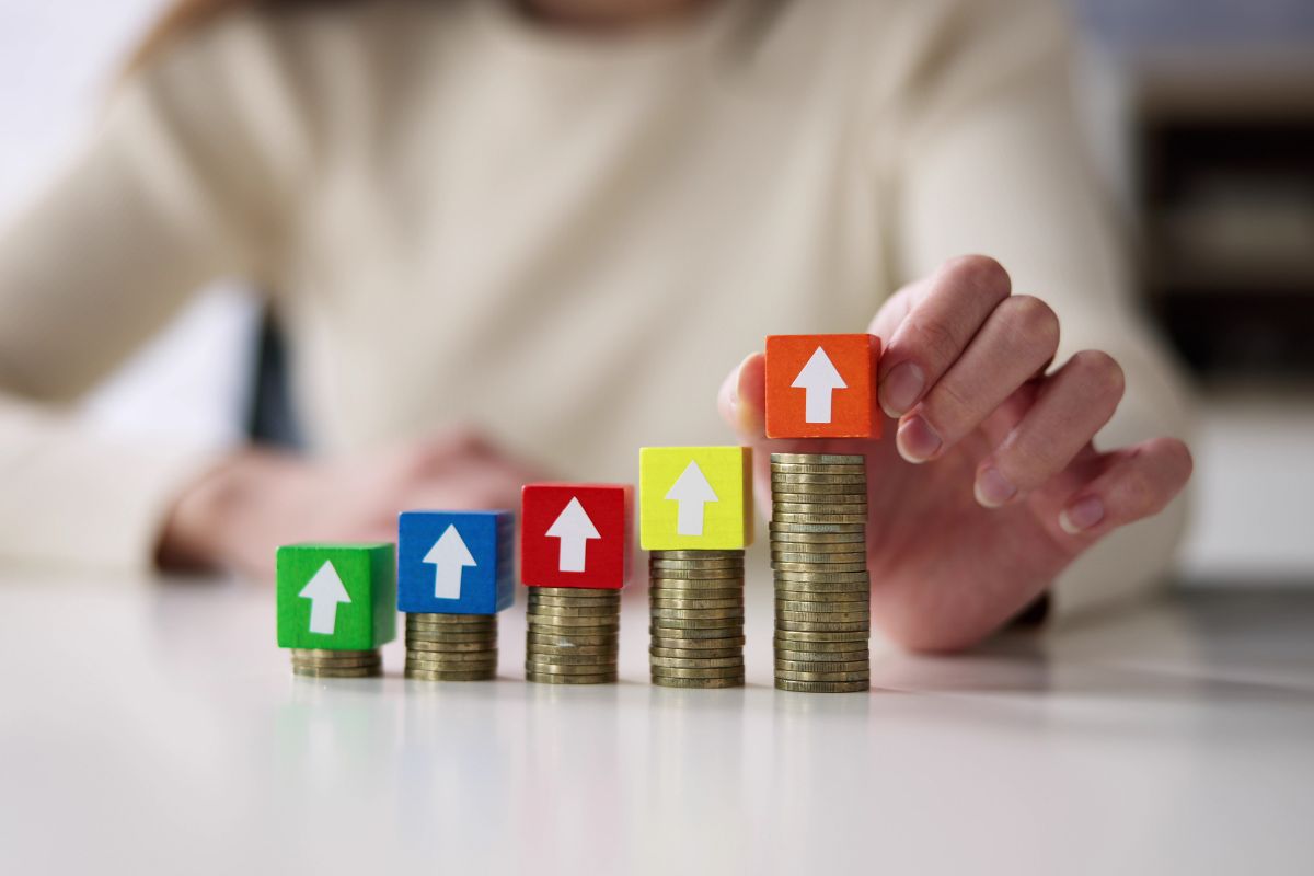 Coins stacking higher and higher, signifying the Medicare cost increase